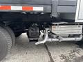 A 2015 Mitsubishi Fuso FE160 truck with visible components such as the engine, exhaust pipe, and undercarriage details