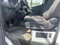 Interior of a 2024 Mercedes-Benz Sprinter showing the driver's seat control panel and seat in black fabric with a partial view of the floor area