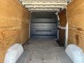A 2016 Mercedes-Benz Sprinter van with a spacious empty cargo area featuring wooden paneling