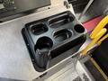 A black cup holder with multiple compartments designed for a 2017 Freightliner MT45 vehicle