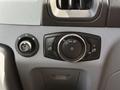 Control panel of a 2016 Ford Transit with various switches including headlight controls and a dimmer knob
