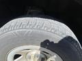 Close-up of a tire from a 2014 GMC Sierra 1500 showing tread patterns and the wheel rim