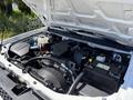 The image shows a 2011 Chevrolet Colorado with its hood open revealing the engine compartment and components including the battery and air intake system