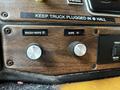 Close-up of control knobs in a 1995 Freightliner FL086 featuring wash-wipe and wipe functions with labeled switches and a wooden panel background
