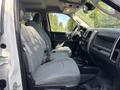 Interior of a 2013 RAM 5500 showing two front seats in gray fabric with seatbelts and a view of the dashboard and steering wheel