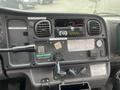 Dashboard of a 2007 Freightliner B2 featuring various gauges switches and a radio with visible wiring and labels
