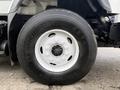 A close-up of a Michelin tire mounted on a 2013 International Workstar 7500 with a white rim and visible wheel bolts