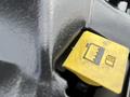 Close-up of a yellow fuel cap featuring a fuel pump icon on a 2015 RAM 2500