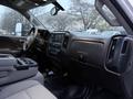 Interior view of a 2017 GMC Sierra 3500HD showing the dashboard steering wheel and seats with a focus on the central console and controls