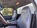 Interior of a 2016 Ford F-750 showcasing two gray vinyl seats with a steering wheel visible in the foreground