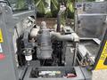 A Wacker Neuson WL34 engine compartment showing the engine components including air intake, turbocharger, and filters