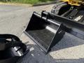 A black excavator bucket designed for a 2022 Caterpillar 306 with a smooth surface and mounting points visible on the underside