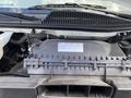 2023 GMC Savana engine compartment showing various components including a black plastic cover and hoses
