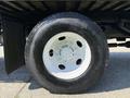 A close-up of a white wheel on a 2008 Ford F-750 truck showcasing its tire and rim details