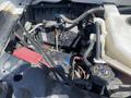 A 2020 Chevrolet Express with visible battery and engine components in an open hood setup