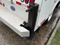 The rear of a 2024 RAM 5500 with a step bumper featuring a hitch receiver and a sturdy black mounting bracket