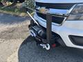A 2017 Chevrolet Colorado with a winch mounted at the front and a metal frame surrounding it