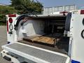 A 2017 Chevrolet Colorado truck with an open bed revealing wooden planks and tool storage in the rear compartment