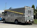 A silver 2009 Morgan Olson Workhorse W62 truck with multiple compartments and a yellow ladder extending from the roof