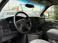 Interior view of a 2004 Chevrolet Express showing the steering wheel dashboard and center console with cup holders