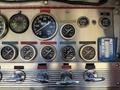 Close-up of a control panel with various gauges and dials for pressure and water levels on a 1992 Emergency One Typhoon Superior fire truck