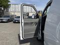A 2008 Ford Econoline van with the driver's door open showcasing the interior door panel and side mirror
