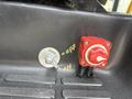 A close-up of a power switch and a pull start mechanism on a tool or equipment box inside a 2018 Chevrolet Express