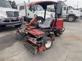 A red 2011 Toro Reelmaster 3100-D turf mower with a seating area for one operator and multiple cutting reels at the front