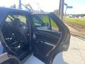 A 2020 Ford Explorer with an open rear door showcasing the interior seating and dashboard details