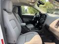 Interior view of a 2017 Chevrolet Colorado showcasing gray fabric seats and a central console with a touchscreen display and gear shift