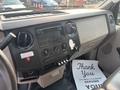 Interior view of a 2009 Ford F-550 dashboard featuring controls for air conditioning radio and an instrument panel with a thank you note on the floor