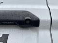 Close-up of the rear camera of a 2019 Ford Transit Connect with droplets of water on the surface