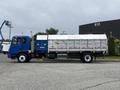 A blue 2017 Autocar Xpert flatbed truck with a silver rear container designed for hauling materials
