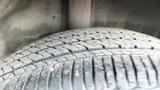 A close-up view of a tire with visible tread patterns mounted on a 2019 Nissan Kicks