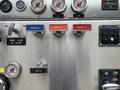 A control panel from a 2002 GMC C7500 featuring various gauges buttons for discharge and crosslay valves along with labels for tank fill and foam
