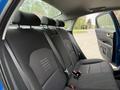 Interior view of the back seat of a 2021 Kia Forte showing two headrests and seatbelt buckles with black fabric upholstery