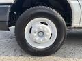 Close-up of a white wheel on a 2008 Ford Econoline featuring a silver rim and black tire with visible tread patterns