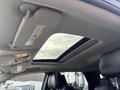 Interior view of a 2015 Dodge Durango showcasing the ceiling and a panoramic sunroof with a light fixture and visors visible