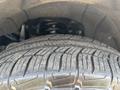 Close-up of a tire with deep treads on a 2017 Chevrolet Colorado showcasing its rugged design and durability