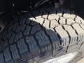 The tread of a tire from a 2018 Ford F-150 showing deep grooves and a rugged design suitable for off-road conditions