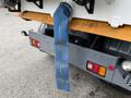 A 2009 UD Trucks UD 3300 with a blue exhaust pipe hanging down from the rear of the vehicle