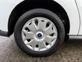 The image shows a close-up of a silver wheel rim with a blue Ford logo on a 2017 Ford Transit Connect tire designed for practical use