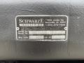 A metal identification plate featuring the text "Schwarze Industries" along with a serial number and model information for a 2013 International DuraStar 4300