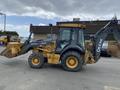 A 2012 John Deere 310SJ backhoe loader with a yellow and black color scheme featuring a front loader bucket and rear digging arm