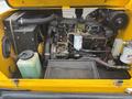 Engine compartment of a 2004 Bombardier SW48 showing the engine assembly with various components including hoses filters and fluid containers