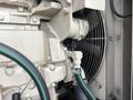 Close-up of a 2005 Katolight SED60FPJ4 generator showing engine components and cooling fan with hoses connected