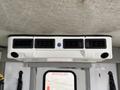 Ceiling-mounted air control unit with multiple vents and a blue button in a 2015 Chevrolet Express interior