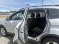 A 2014 Ford Escape with an open front door revealing the interior seating and dashboard