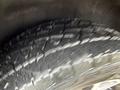 Close-up of a tire from a 2019 Jeep Grand Cherokee showing detailed tread pattern with visible wear marks