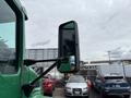 A 2013 Kenworth T370 truck side mirror with a green frame and large reflective surface